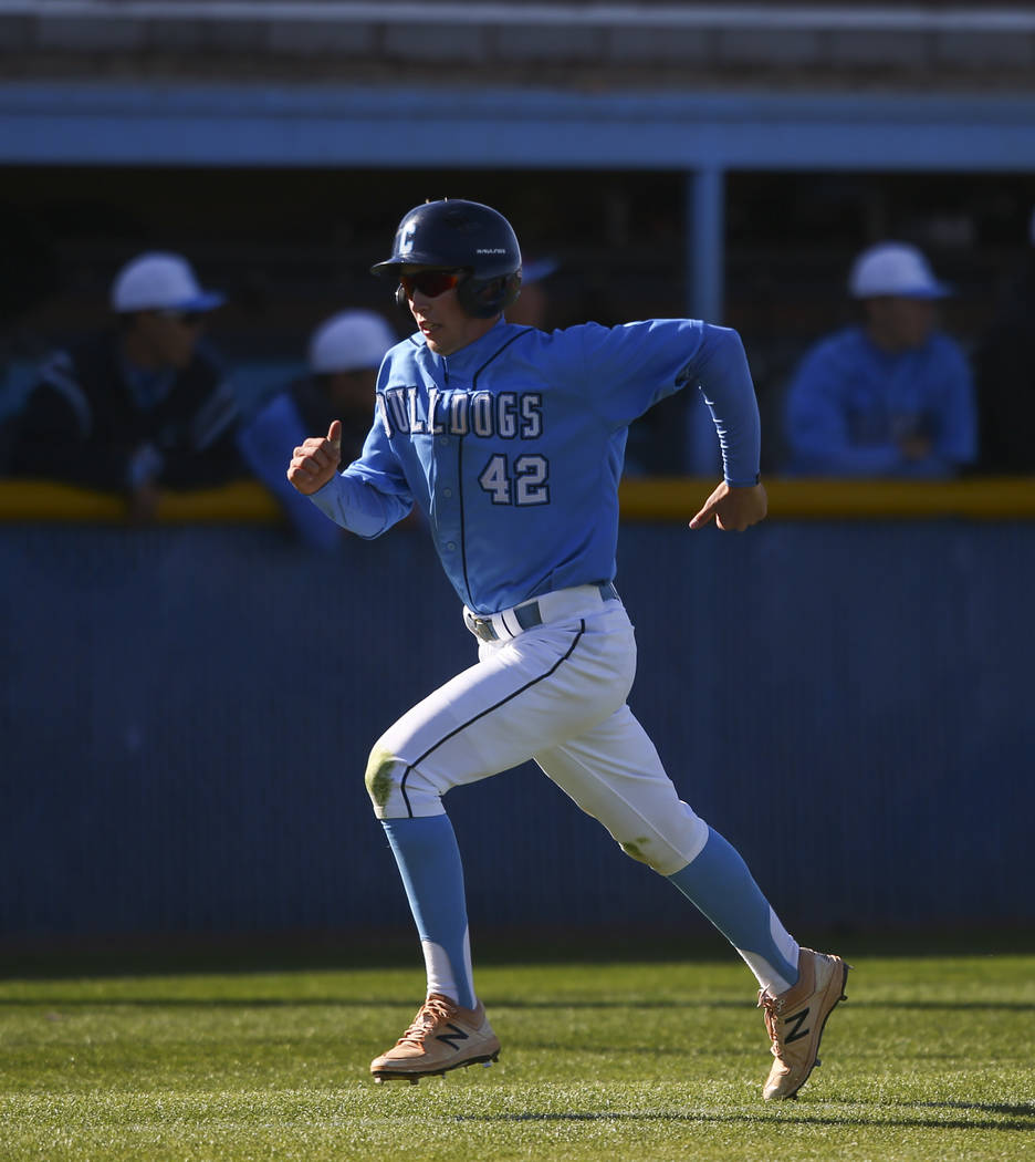 Centennial’s Jake Rogers (42) heads for home base to score a run against Cimarron-Memo ...