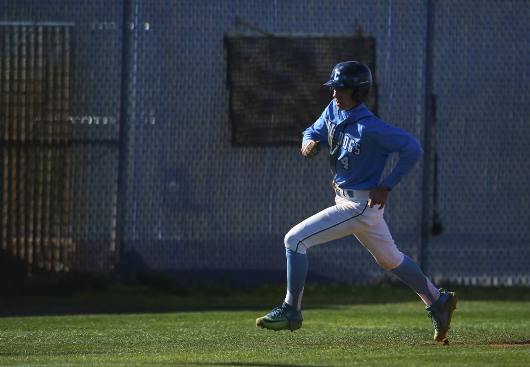 Centennial’s Kian Wilbur (4) heads for home base to score a run against Cimarron-Memor ...