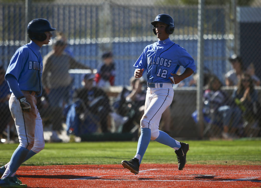 Centennial’s Gino Sabey (12) scores a run against Cimarron-Memorial during a baseball ...