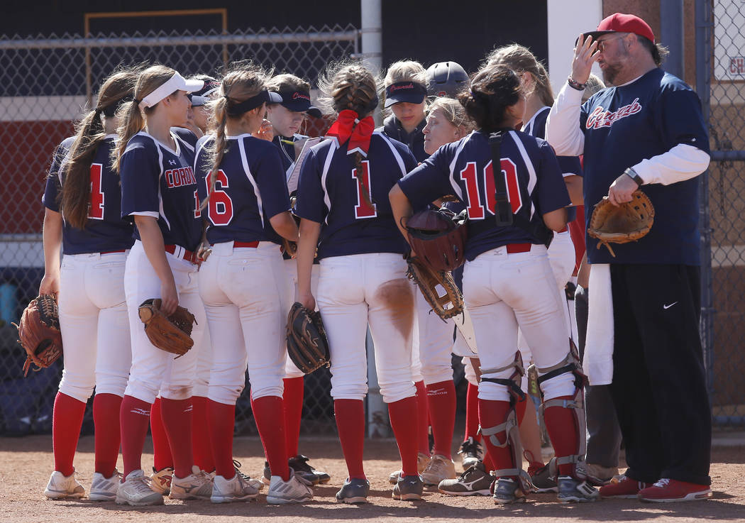 Coronado players huddle during the second inning of a high school softball game against Libe ...