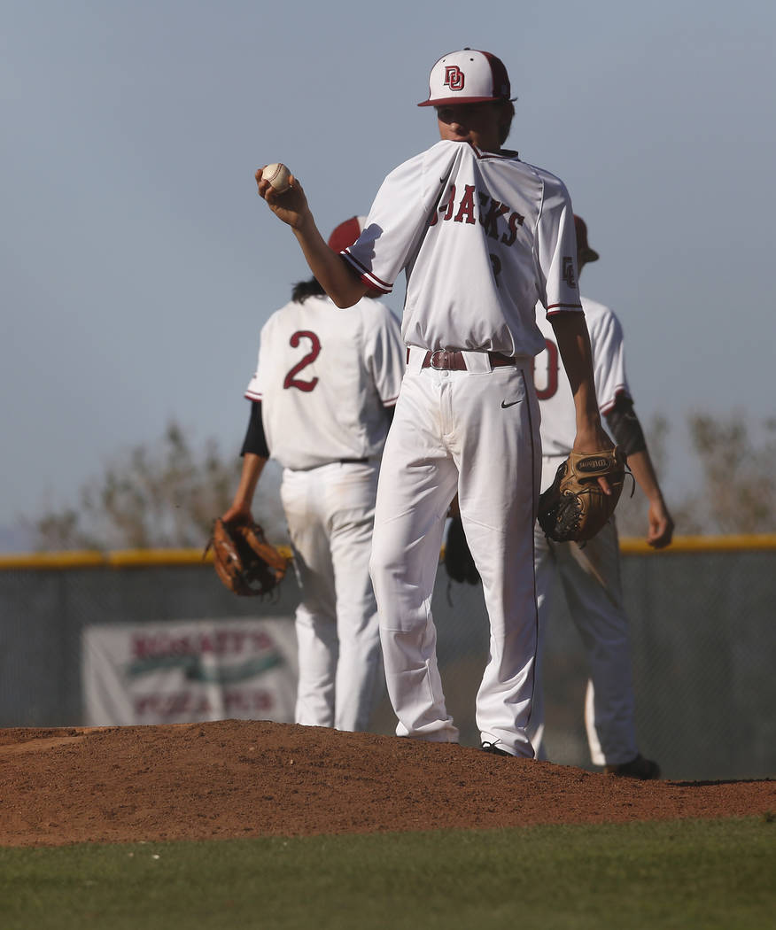 Desert Oasis’s Dustin Mansell (8) walks to the base as a relief pitched during the six ...