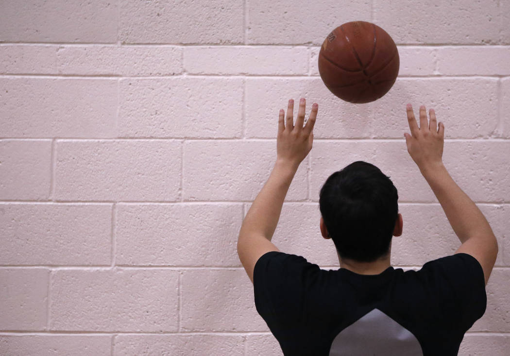 Senior setter Edher Aldaco practice his setting skills with a basketball during volleyball p ...