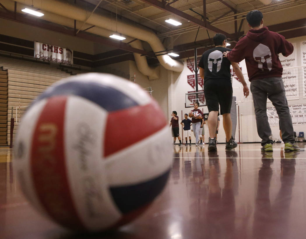 Head coach Sopheap Khuon speaks to the volleyball team during practice at Cimarron-Memorial ...
