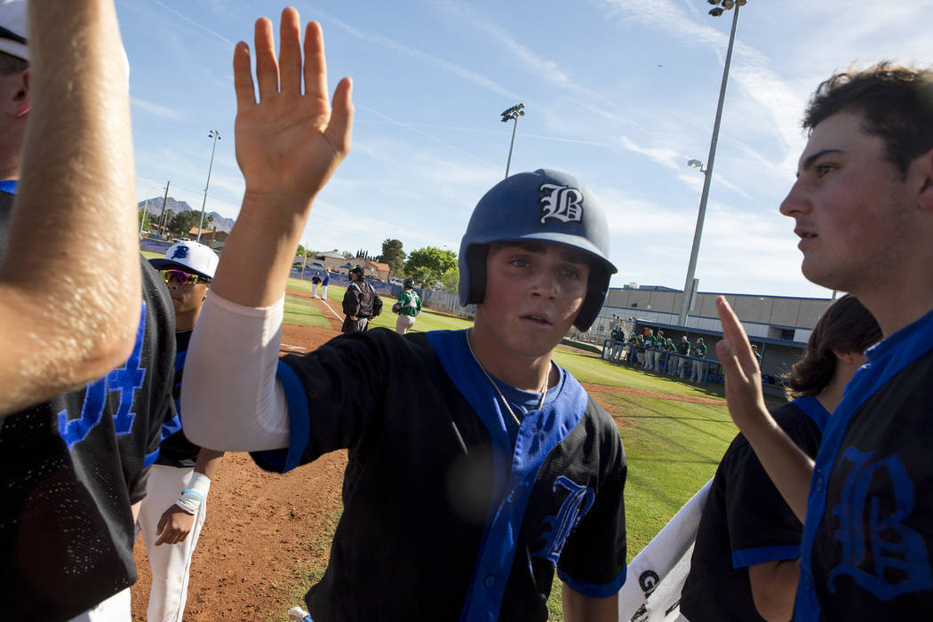 Basic players celebrate a strong inning against Green Valley at Basic High School Wednesday, ...