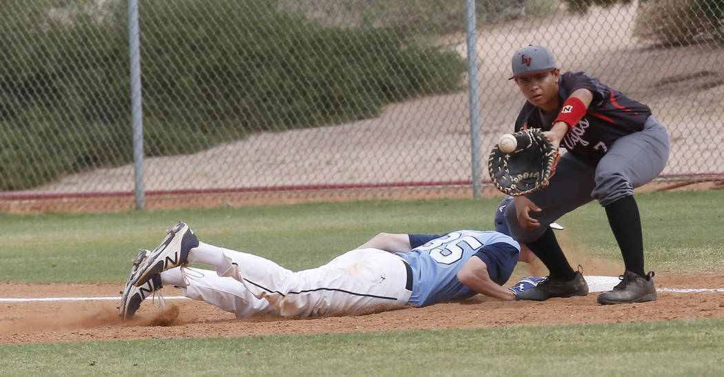 Foothill’s Gage Streit (35) dives for first base as Las Vegas’s Payton Miller (7 ...
