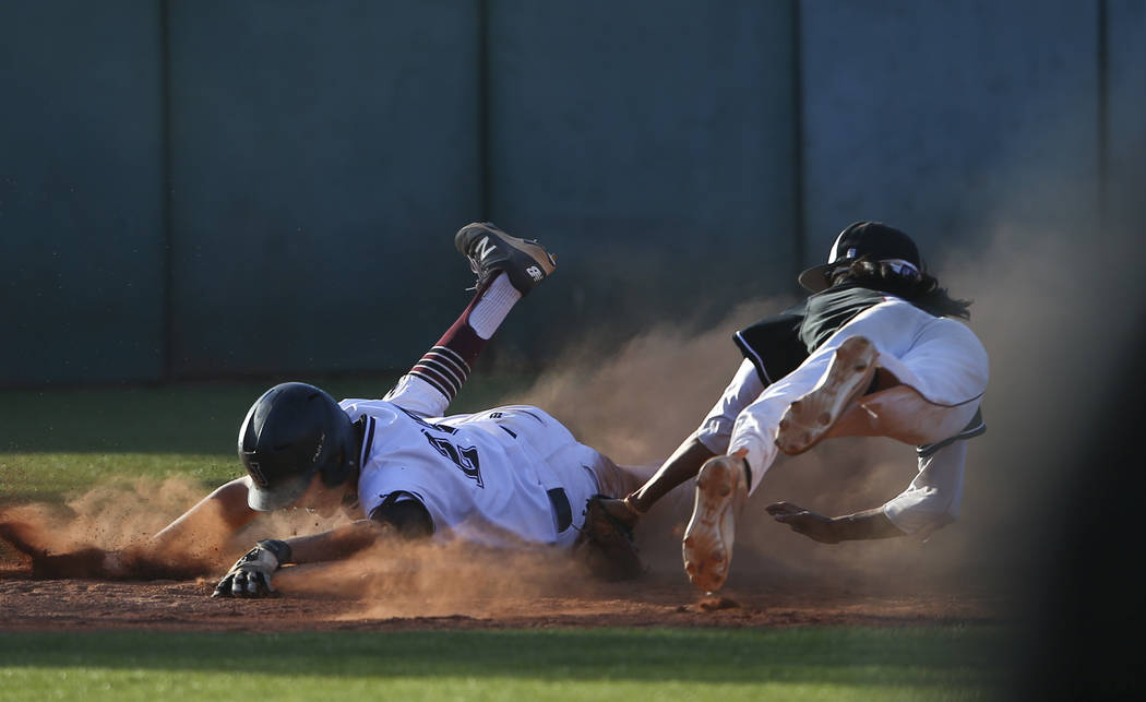 Jordan’s Robbie Gallo (24) slides safely into third base as Desert Oasis’ Andrew ...
