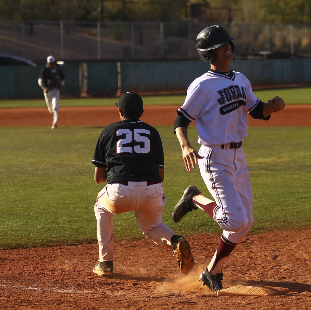 Jordan’s Conner Hughes (4) gets tagged out by Desert Oasis’ Aaron Roberts (25) d ...