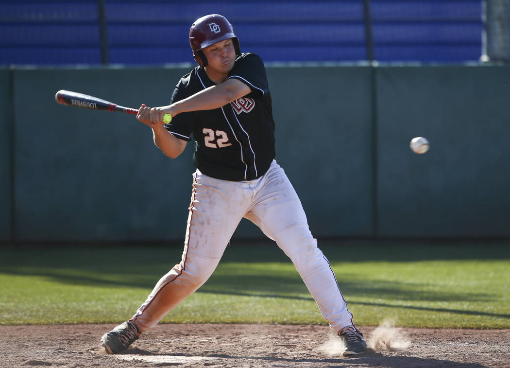 Desert Oasis’ Chaison Miklich (22) swings at a pitch from Jordan during the Bishop Gor ...