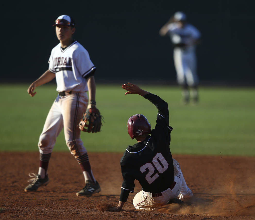 Desert Oasis’ Jordan DeMarce (20) slides into second base against Jordan’s Robbi ...