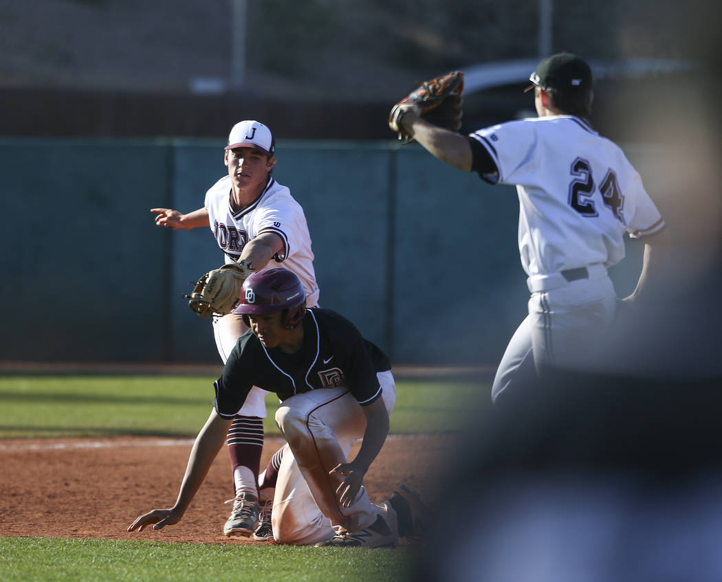 Desert Oasis’ Aaron Roberts (25) gets tagged out by Jordan’s Noah Hennings (5) d ...