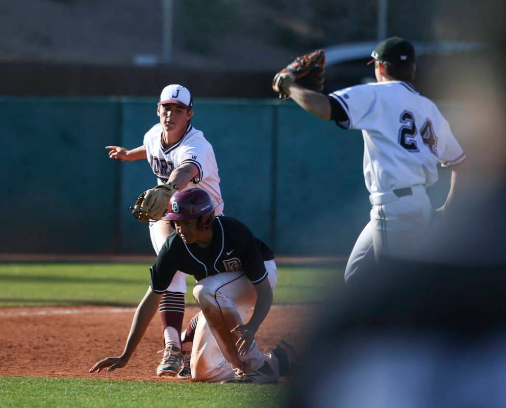 Desert Oasis’ Aaron Roberts (25) gets tagged out by Jordan’s Noah Hennings (5) d ...
