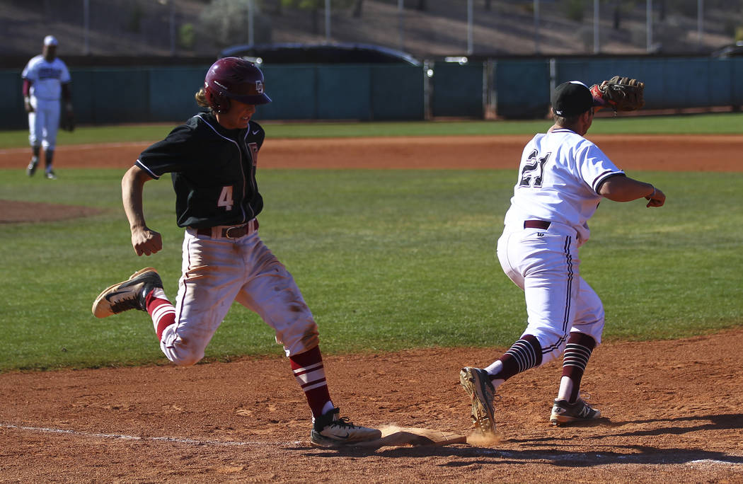 Desert Oasis’ Parker Schmidt (4) gets tagged out at first base by Jordan’s Gage ...