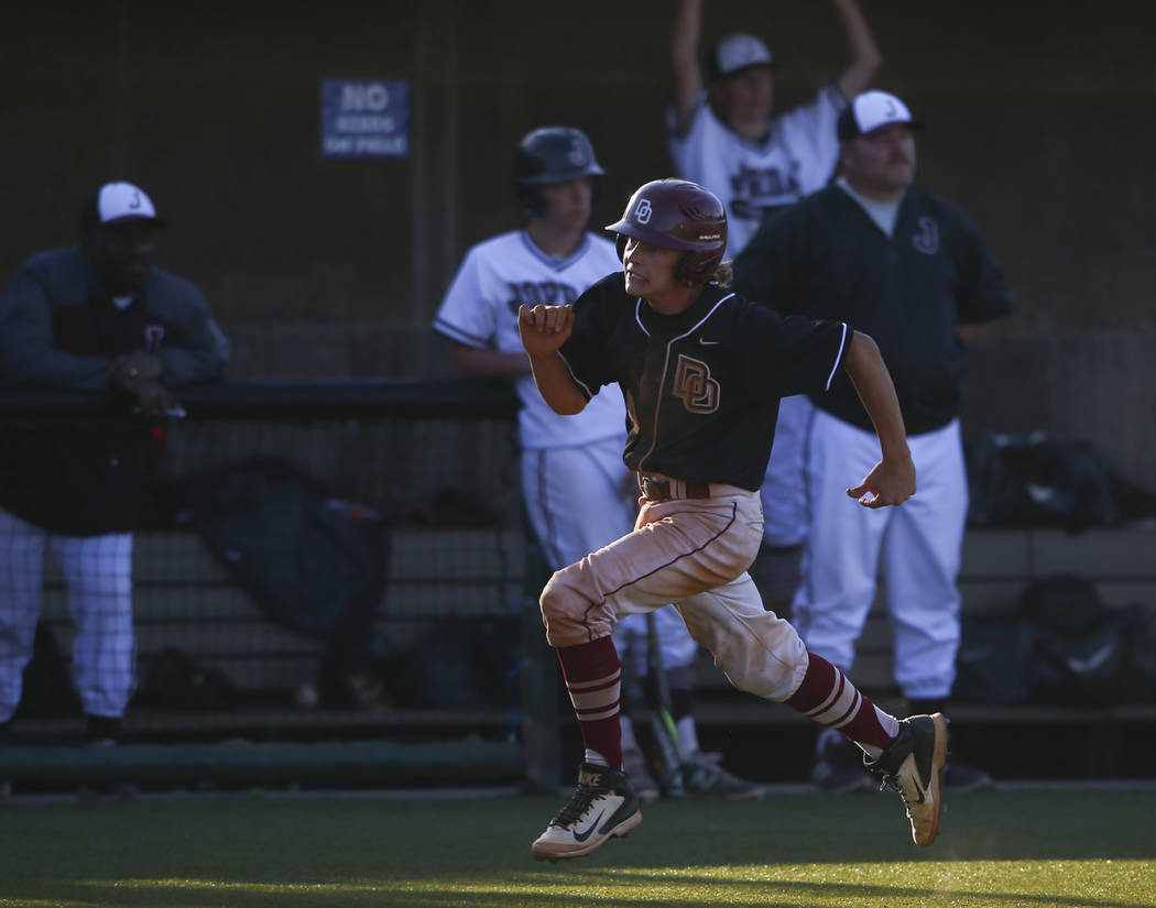 Desert Oasis’ Parker Schmidt (4) heads to home base to score a run against Jordan duri ...