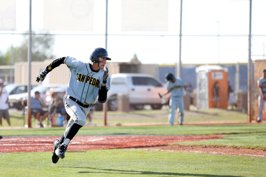 San Pedro’s (Calif.) Martiliano Fernandez (16) sprints to first base successfully agai ...