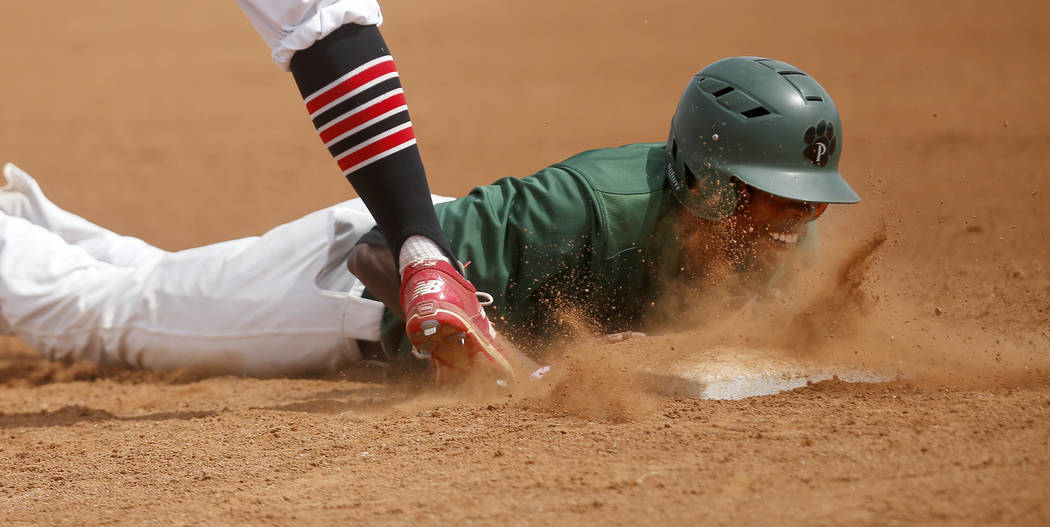 Palo Verde’s Wesley Cosby (6) dives for first base after leading off of it during the ...