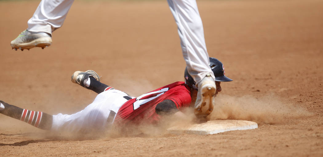 Banning’s Omar Muro (11) dives for first base after leading off of it during the fifth ...