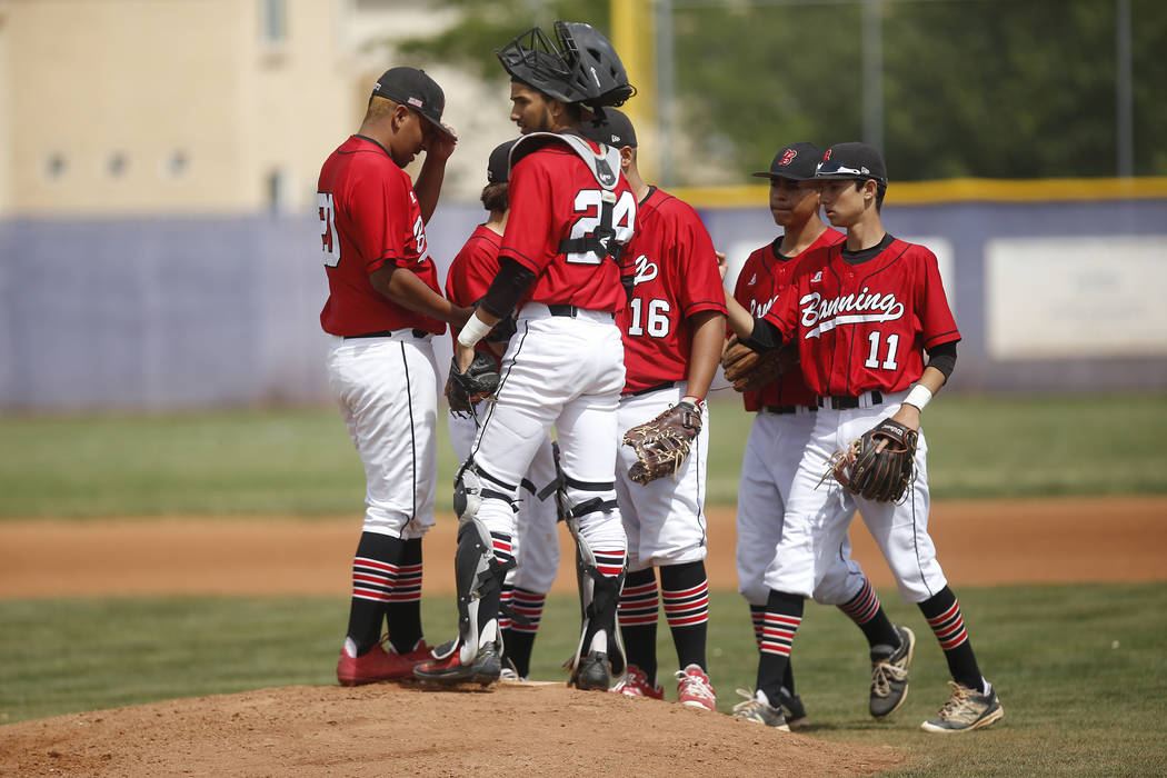 Banning players gather on the mound during the first inning of a high school baseball game a ...