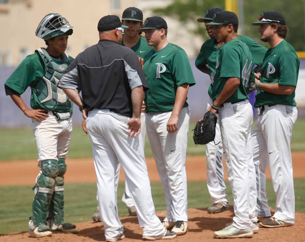 Palo Verde players gather at the mound during the second inning of a high school baseball ga ...