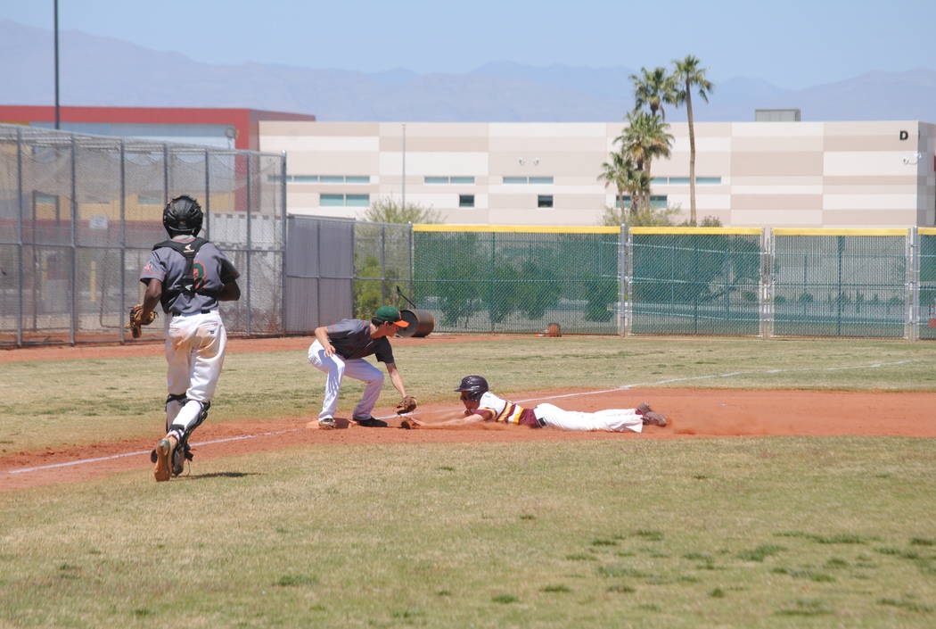 A Pahrump Valley player attempts to slide into third base on Wednesday. The Trojans beat Moj ...