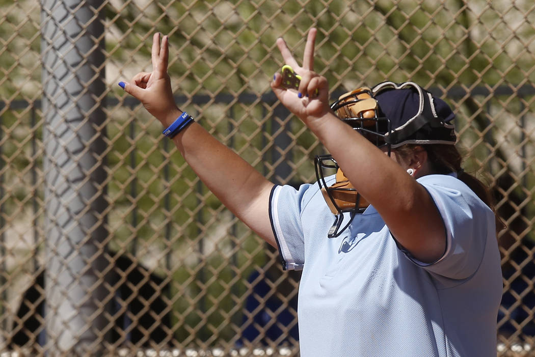 An umpire signals the pitch count during a high school softball game at Majestic Park on Thu ...