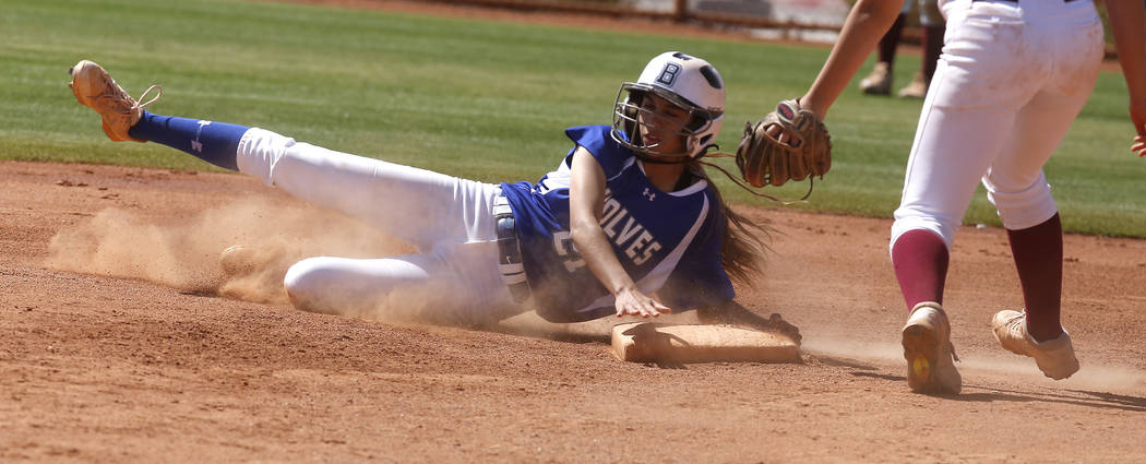 Basic’s Alyssa Ferguson (21) is safe at first base during a high school softball game ...