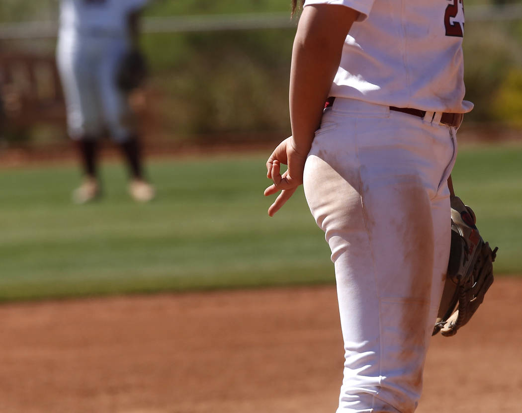 A Desert Oasis player signals towards her teammates during a high school softball game at Ma ...
