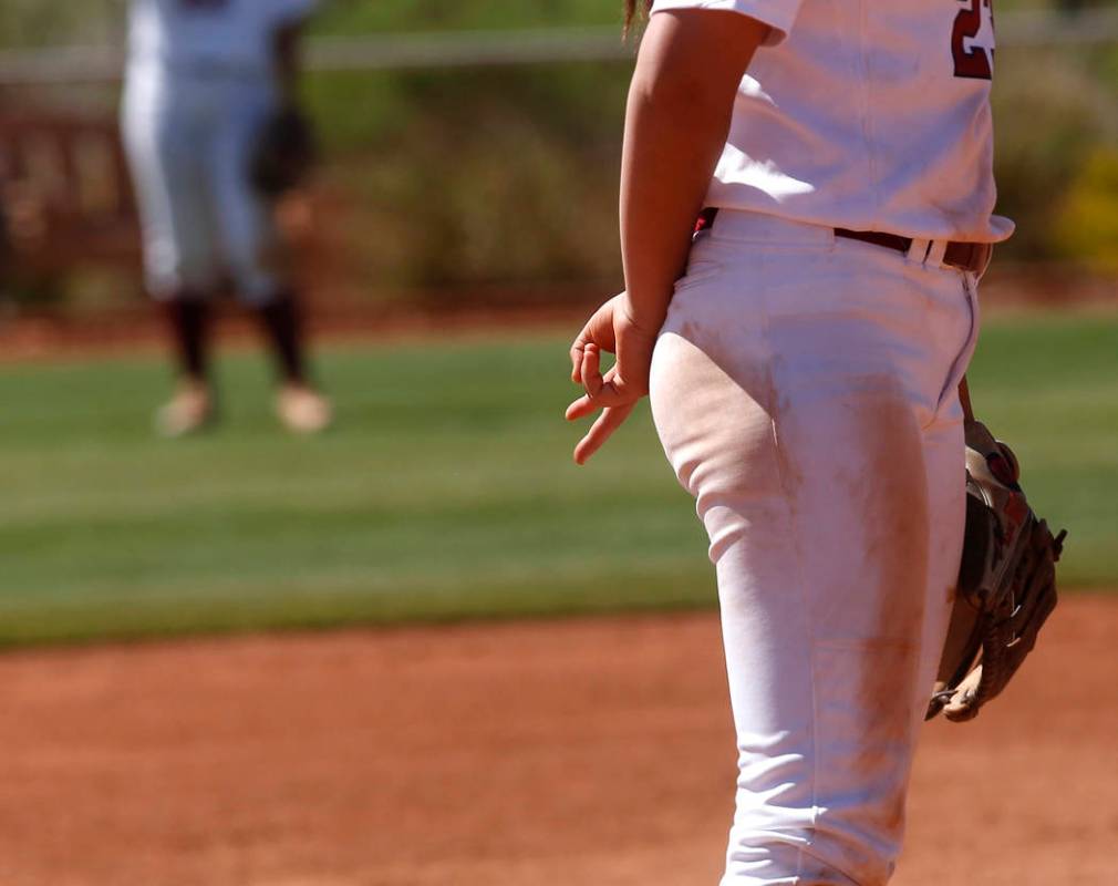 A Desert Oasis player signals towards her teammates during a high school softball game at Ma ...