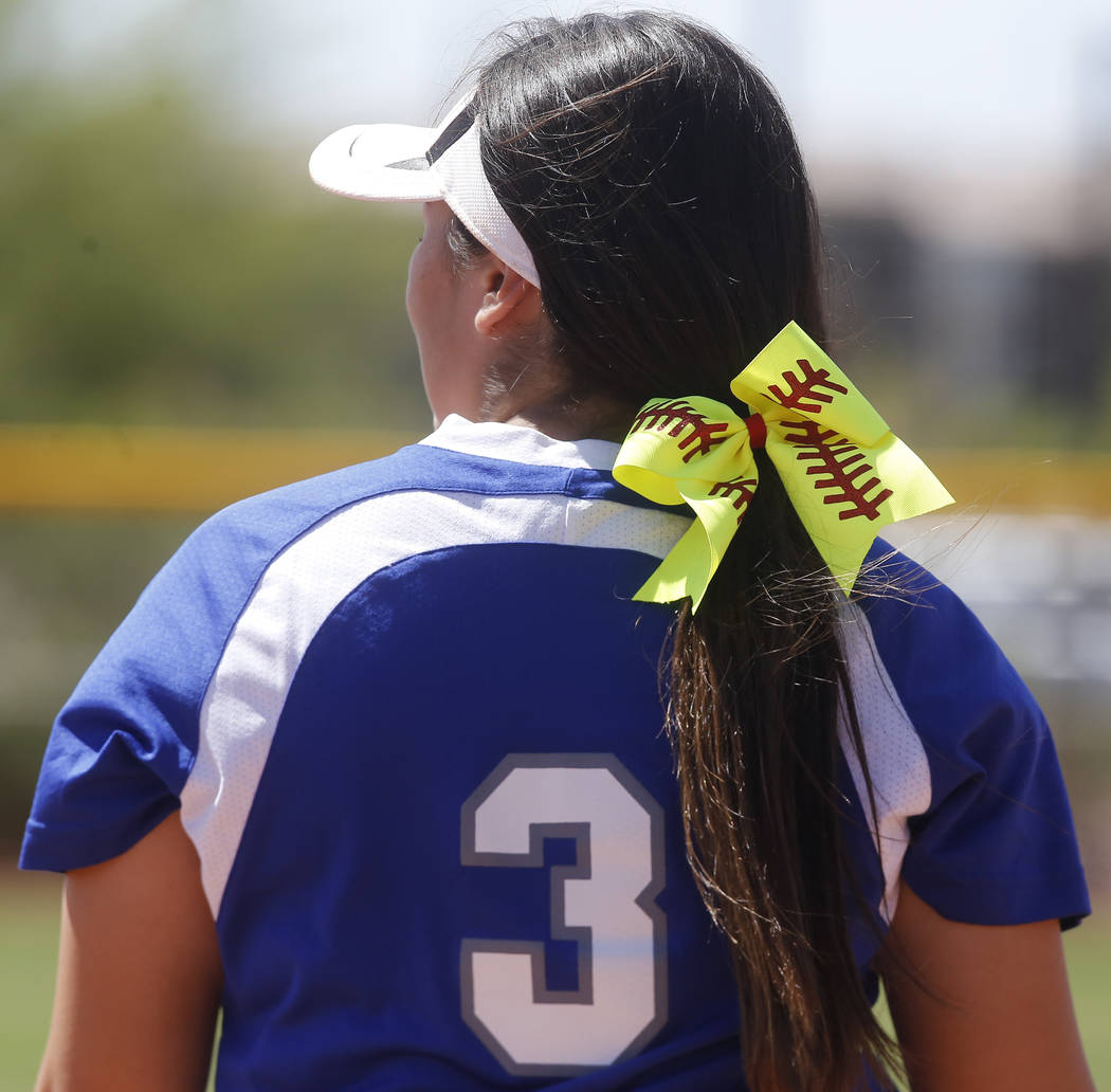 A softball themed ribbon in the hair of Basic’s Adalena Clayton (3) during a high scho ...