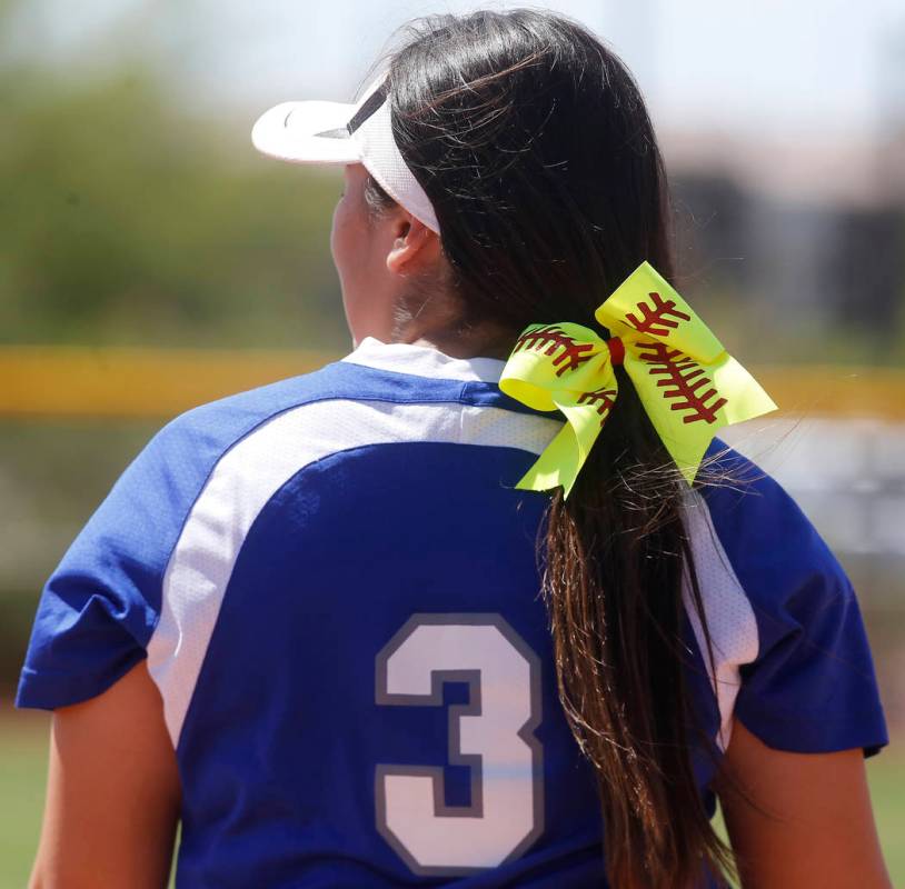 A softball themed ribbon in the hair of Basic’s Adalena Clayton (3) during a high scho ...