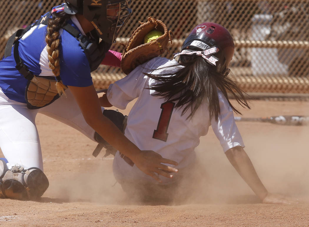 Desert Oasis’s Yahirda Pelegrina (1) is tagged out at home plate during a high school ...