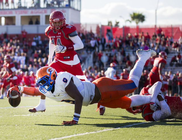 Brevin Jordan (9), dives with the ball during the Sunset Region football final between Bisho ...