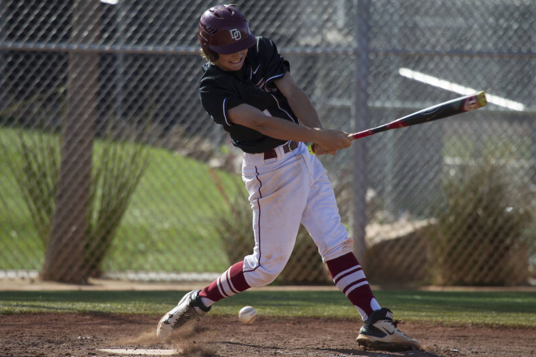 Desert Oasis’ Cesar Sedano (4) swings the bat against Bishop Gorman at Desert Oasis Hi ...