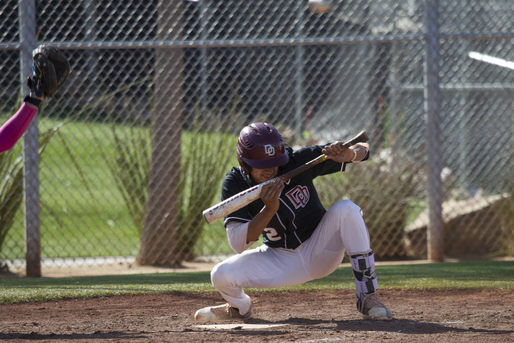 Desert Oasis’ Tyler Curtis (2) ducks a low pitch against Bishop Gorman at Desert Oasis ...