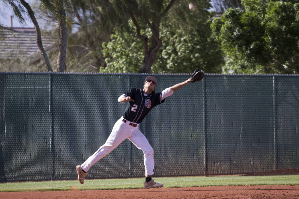 Desert Oasis’ Andrew Martinez (2) reaches for a catch and an out against Bishop Gorman ...