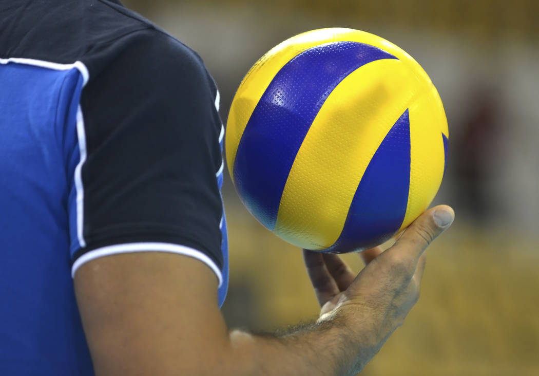 Volleyballplayer with a volleyball in his right hand