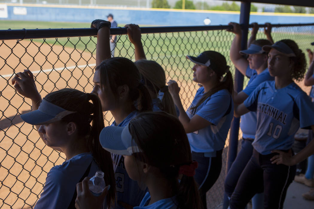 Centennial teammates watch the first inning from the dugout during a game against Shadow Rid ...