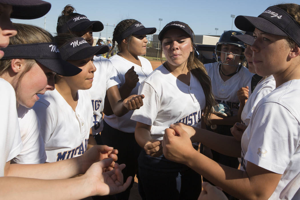 Shadow Ridge teammates gather for a cheer between innings during a a game against Centennial ...