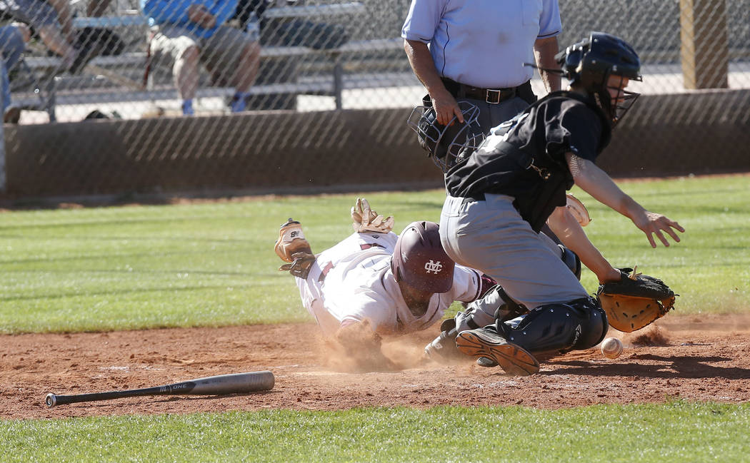 Cimarron-Memorial’s Daniel Valdivia (1) is safe at home plate during the fourth inning ...
