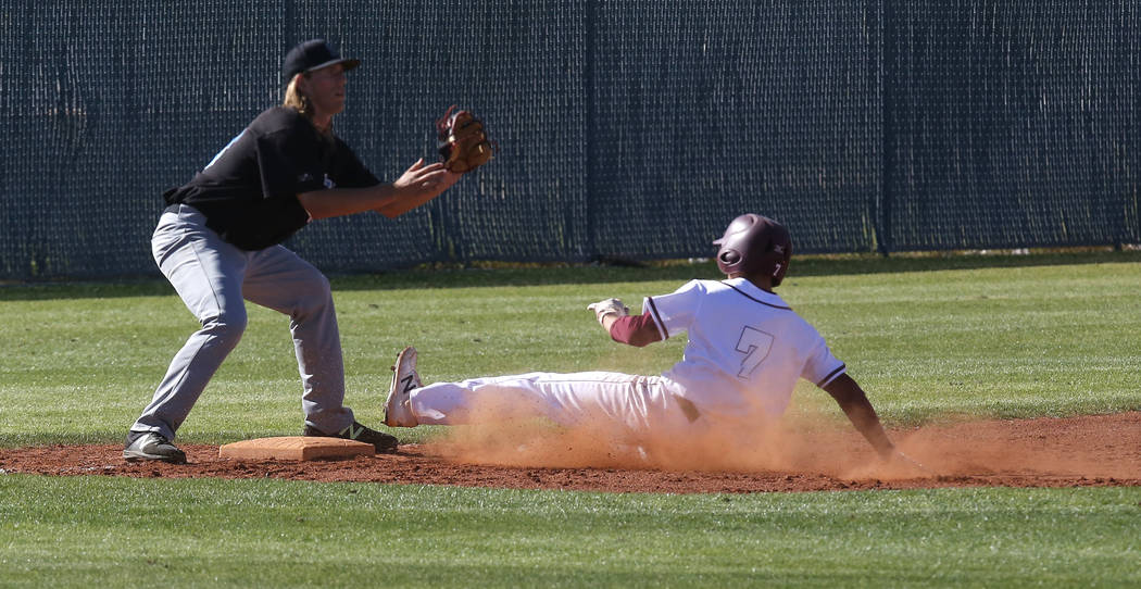 Cimarron-Memorial’s Zach Culver (7) slides for third base during the fourth inning of ...