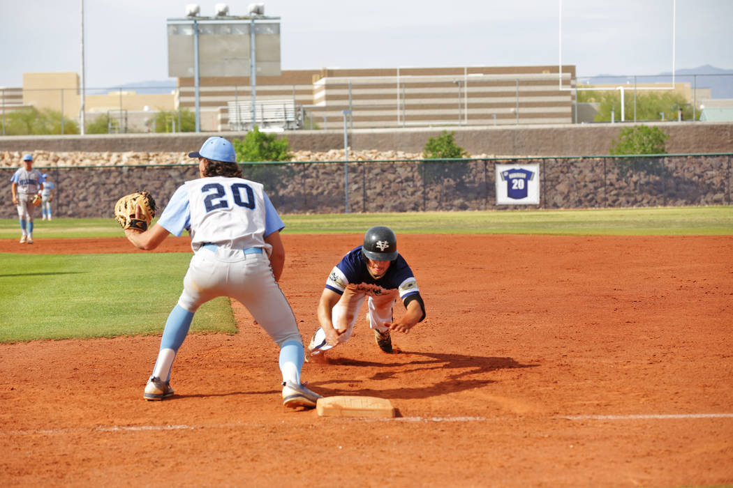 Spring Valley’s Jack Sellinger (17) prepares to dive for first base against Centennial ...