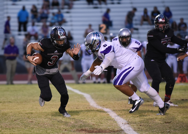 Desert Oasis Jaden Mitchell (3) runs the ball against Silverado’s Jordan Walker (6) du ...