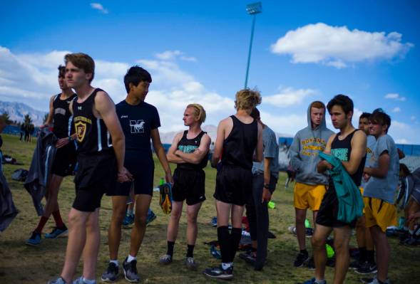 Palo Verde’s Ben Slighting, fourth from left, waits to check in for the 1600-meter run ...