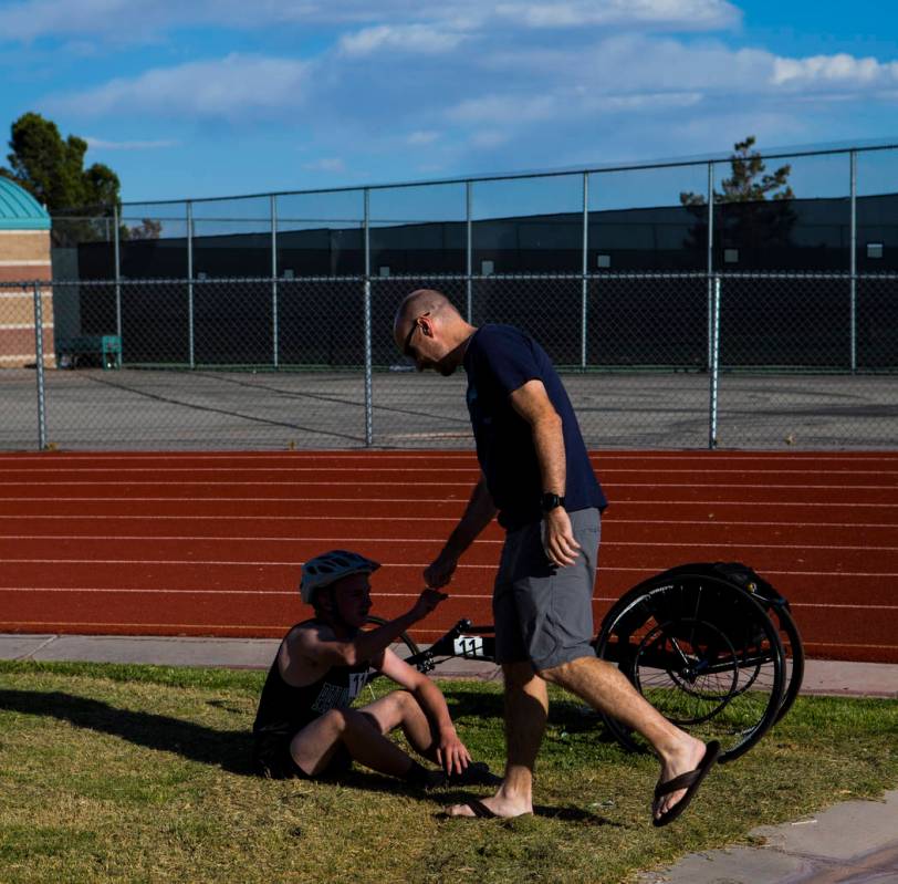 Palo Verde’s Ben Slighting, who competes in a wheelchair, fist bumps his dad, Brad, af ...