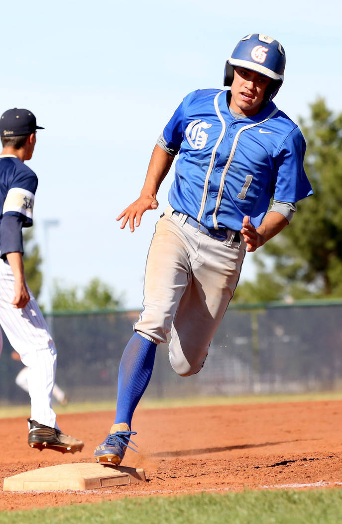Bishop Gorman’s Jorel Hingada rounds the third base to successfully make it home in th ...