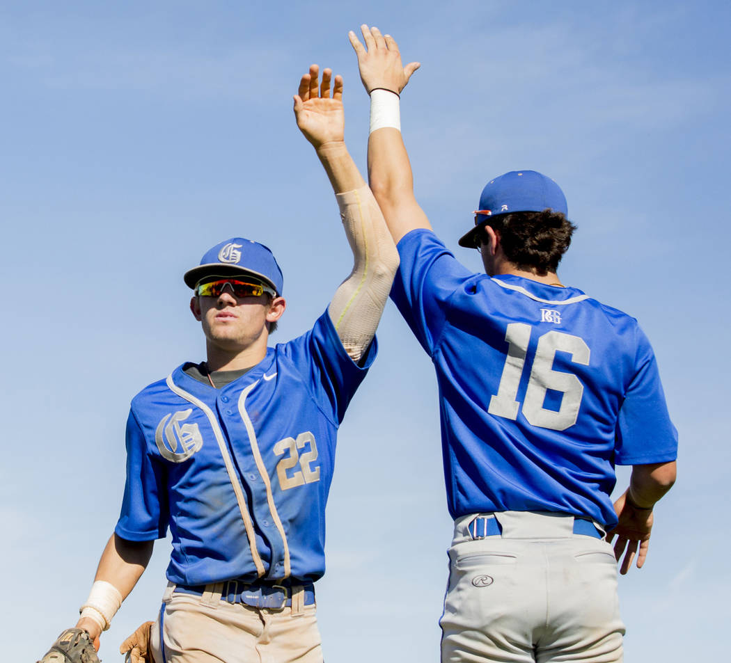 Bishop Gorman’s Braxton Wehrle (22), left, and Austin Wells (16), high-five during a g ...