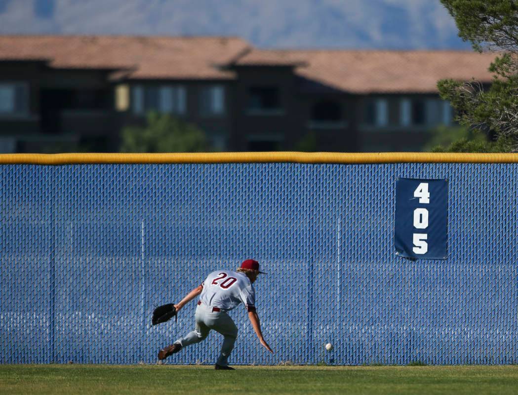 Desert Oasis’ Jordan DeMarce (20) chases down a fly ball from Centennial during a Suns ...