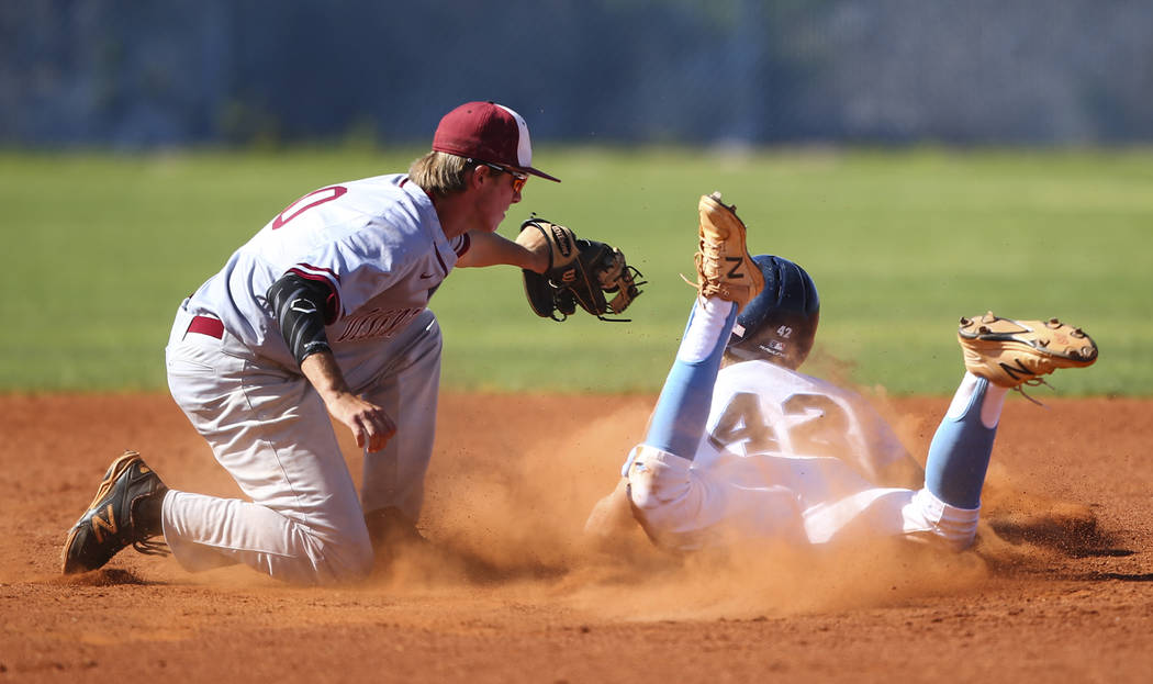 Desert Oasis’ Cole Schaefer tags out Centennial’s Jake Rogers (42) during a Suns ...