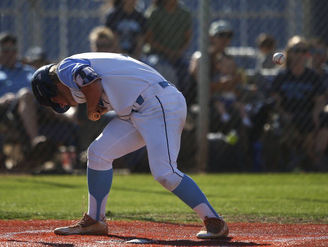 Centennial’s Austin Kryszczuk reacts after getting hit in the head by a pitch from Des ...
