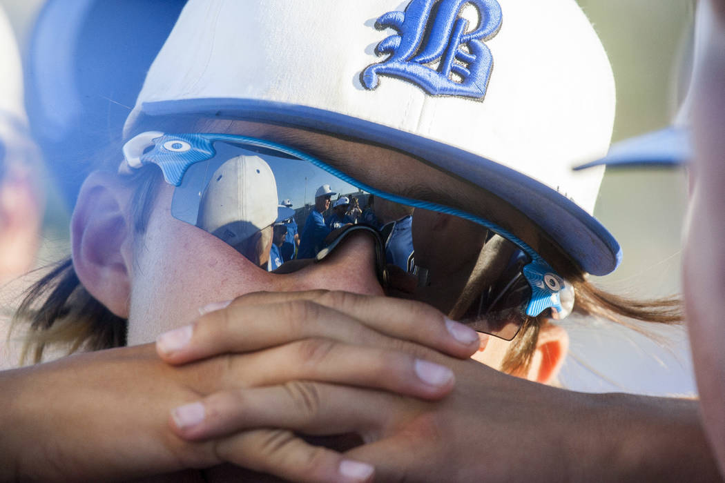 Basic players are reflected in sunglasses during a post-game huddle after their victory agai ...
