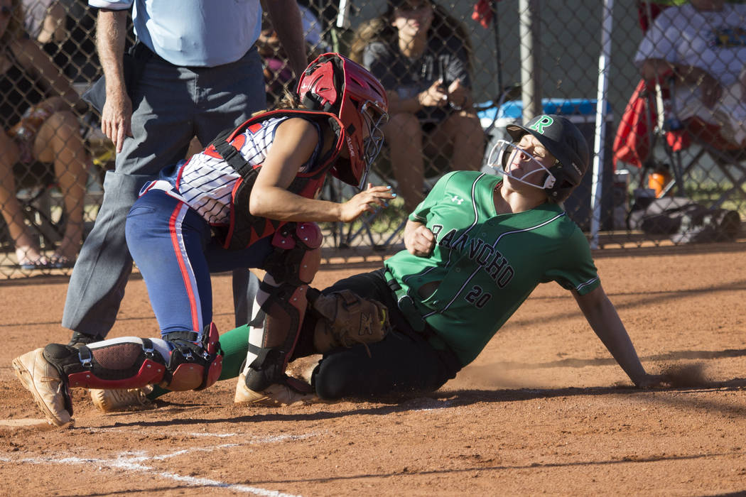 Rancho’s MacKenzie Perry (20) is tagged out at home plate against Liberty’s Kyli ...